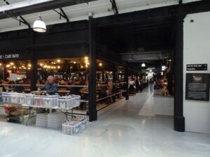 stalls inside a busy indoor market hall