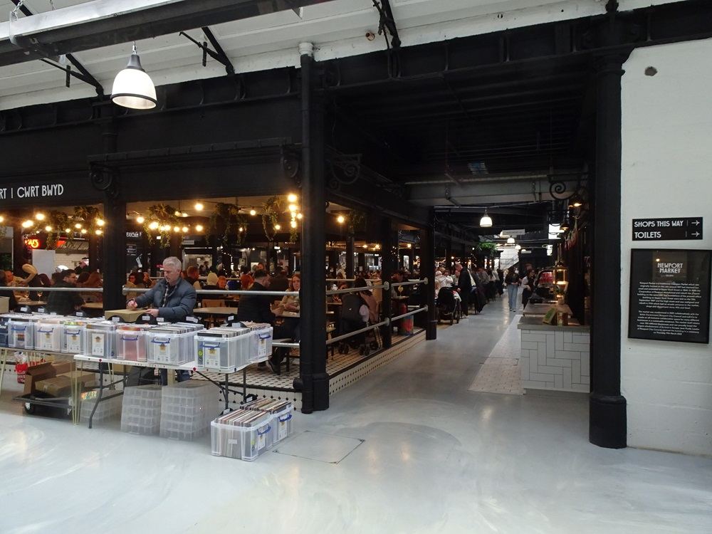 stalls inside a busy indoor market hall